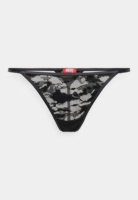 Fio dental em malha preta com um padrão de camuflagem, alças finas e uma etiqueta do logótipo vermelho da Diesel na cintura. Design leve e transparente.