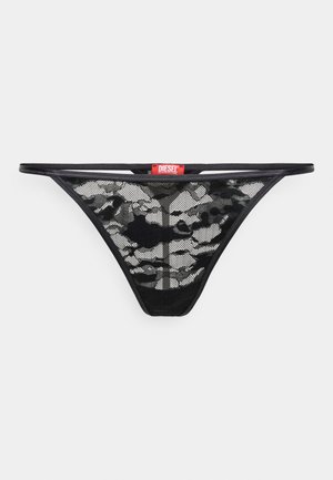 Czarny przezroczysty thong z siateczki z wzorem moro, cienkimi paskami i czerwoną metką Diesel na pasie. Lekka i przezroczysta konstrukcja.