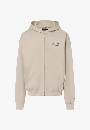 Hiver beige à fermeture éclair en coton, doté d'une poche kangourou, de poignets côtelés et d'un petit logo sur la poitrine. Texture douce.