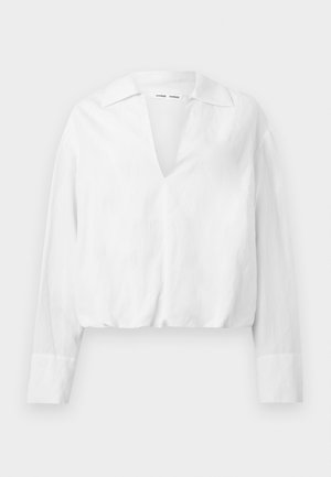 Long-sleeve white blouse with wide collar and deep V-neck, featuring elasticized hem and cuffed sleeves.