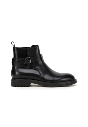Black leather ankle boots featuring a smooth texture, buckle detail on the side, and a rugged sole for grip and durability.