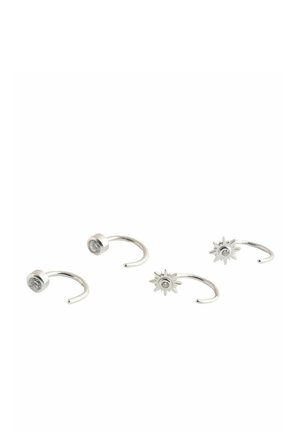 Set of four silver nose rings, two with round clear stones and two with star-shaped designs featuring central stones, displayed on white background.