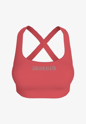 Red sports bra with crossed back straps and "Calvin Klein" logo printed in gray on the front.