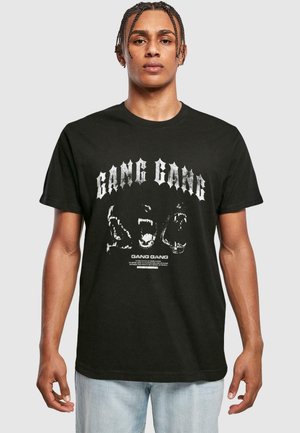 Black cotton t-shirt featuring bold white "GANG GANG" text and graphic designs. Short sleeves, crew neck, and a standard fit.