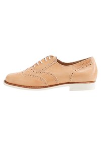 Tan leather brogue-kenkä, jossa on rei'itetty yksityiskohtia, valkoiset nauhat ja matala valkoinen korko, kuivaa pintakäsittelyä ja pyöreä kärki.