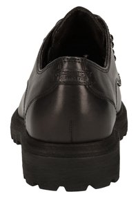 Scarpa in pelle nera con una superficie testurizzata e una suola robusta. Presenta una forma arrotondata e una minimale rifinitura, enfatizzando la durata.