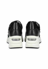 Black leather and suede sneakers with a white sole, featuring silver accents and branding on the heel. Dual-texture design, sporty shape.