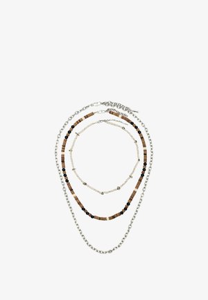 Three layered necklaces with silver chain, brown and black beads, and light-colored small stone beads with black specks.