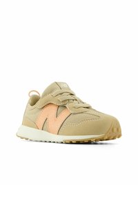 Beige and peach New Balance sneaker with laces, textured side logo, pull tab, and white cushioned sole against a white background.