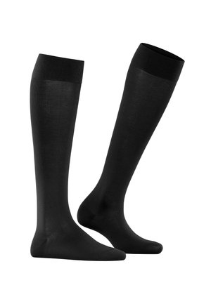 Chaussettes noires montantes avec une texture lisse et un orteil renforcé. Dotées d'un bord ribbé en haut pour un maintien sécurisé.
