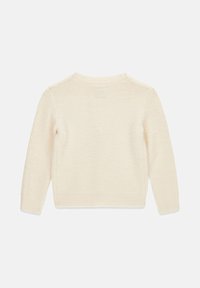 Maglione color crema con maniche lunghe, scollo rotondo, motivo a maglia testurizzata e polsini e orlo a coste. Sottile etichetta del marchio sul retro.