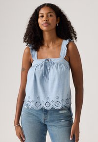 Light blue tank top with ruffled straps, drawstring detail, and embroidered floral pattern along the hem. Smooth fabric, casual cut.