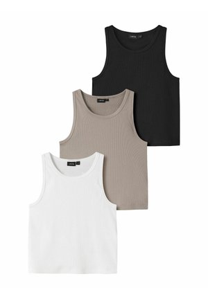 Trois débardeurs sans manches côtelés en noir, beige et blanc, disposés en chevauchement sur un fond blanc.