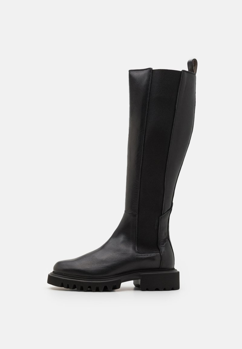 Black leather knee-high boot with a textured panel, rounded toe, chunky rubber sole, and rear pull tab for easy wear.