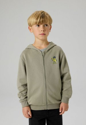 Felpa con cappuccio color khaki con zip, fodera interna grigia, polsini a coste e una grafica gialla giocosa di un personaggio dei cartoni animati sul petto.