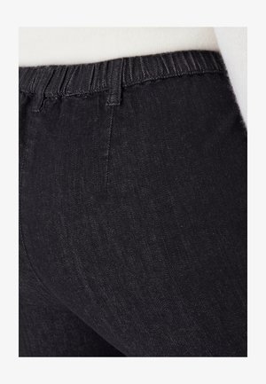 Leggings in denim nero con vita elastica, caratterizzati da una texture liscia e un leggero lucido. Nessuna cucitura o motivo visibile.