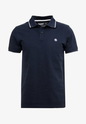 Polo shirt bleu marine en coton, avec une patte de boutonnage à deux boutons, un col blanc et des accents de manches blancs, ainsi qu'un petit logo sur la poitrine.