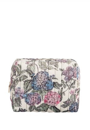Trousse de maquillage matelassée avec un motif floral en rose, bleu et vert sur un fond crème. Accent en zip doré. Forme rectangulaire.
