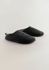 Black corduroy slippers with a soft texture, rounded toes, and a small fabric loop at the back for easy wearing.