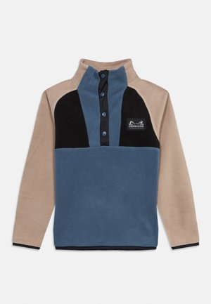 Pull polaire avec manches beige, corps bleu, panneaux noirs sur la poitrine et boutons-pression bleus, avec le logo Didriksons sur la poitrine.