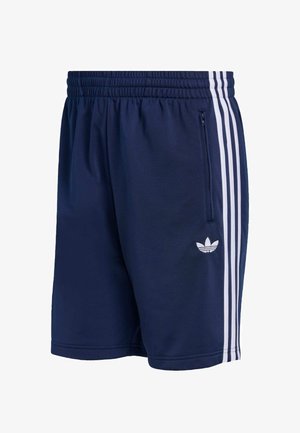 Námořnické atletické šortky s elastickým pasem, bočním zipem a třemi bílými pruhy po stranách. U lemu je logo.