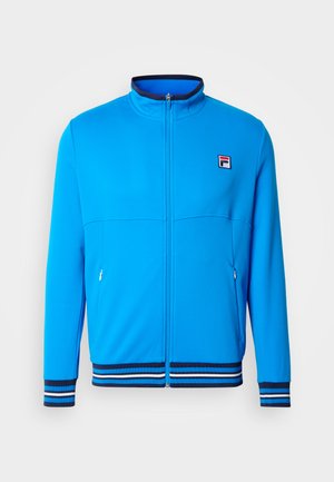 Blue track jacket made of soft fabric. It features a high collar, zip closure, and two side pockets with striped ribbed cuffs and hem.
