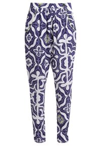 Vzorované bavlněné kalhoty v purpurové, bílé a zelené barvě, zobrazující abstraktní květinový design, s elastickým pasem a bočními kapsami.