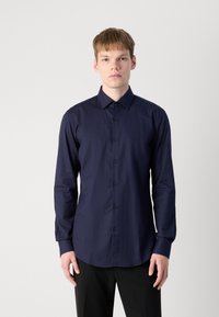 Navy blue long-sleeve shirt with a subtle herringbone pattern, button-up front, and classic collar; smooth texture and fitted design.