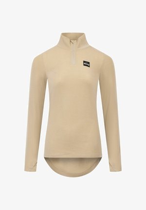Beige long-sleeve zip-up top with ribbed texture, high collar, and a curved hem. Features a black label on the chest.