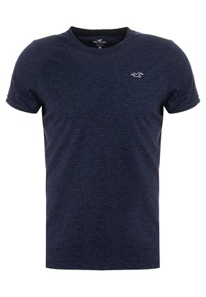 T-shirt bleu marine à manches courtes en tissu doux et texturé, doté d'un col rond et d'un petit logo sur la poitrine.