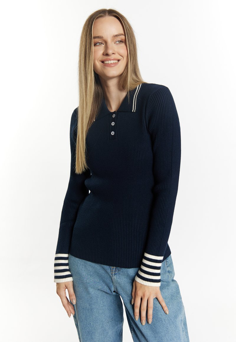 Maglione polo a coste blu navy con apertura a tre bottoni e polsini a righe bianche. Presenta maniche lunghe e una silhouette aderente.