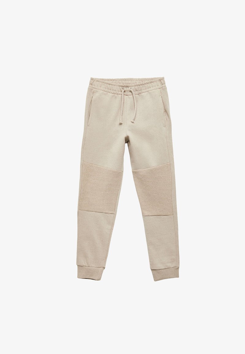 Beige Jogginghosen mit elastischem Bund, Kordelzug, Seitentaschen und strukturierten Knieflicken. Weicher Stoff und schmal zulaufende Bündchen.