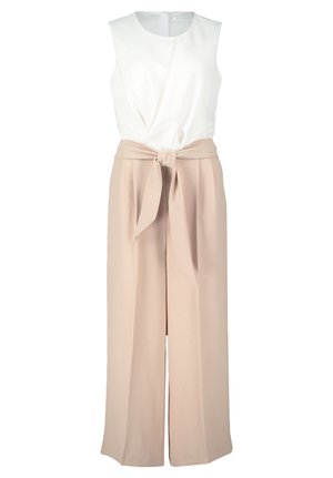 White sleeveless top with a twisted front, paired with high-waisted, loose-fitting beige trousers featuring a tie belt.