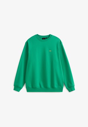 Zielona bluza z okrągłym dekoltem wykonana z miękkiego materiału. Posiada małe złote logo na piersi. Długie rękawy oraz ściągacze na mankietach i u dołu.