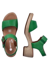 Green leather sandals with a textured wood-like wedge heel, featuring two wide straps and a buckle closure on the side.