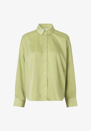 Lys grøn bluse lavet af glat stof, med krave, fuld knaplukning og lange ærmer med knapmanchetter.