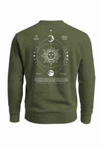 Green sweatshirt with white mystical design featuring sun, moon phases, and text about spiritual awareness and balance on the back.