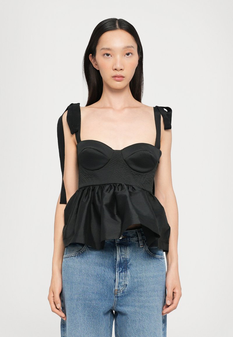 Black peplum top with padded, curved cups and wide fabric straps. Features a textured bodice and a flared, gathered bottom hem.