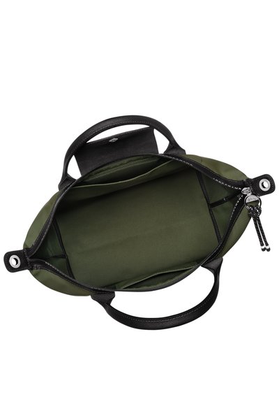 Black bag with textured handles, green interior lining, and zippered pocket. Features oval shape and two front compartments for organization.