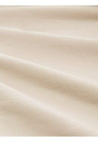 Light beige fabric with a smooth, woven texture, featuring soft folds and subtle sheen, showing off the undulations of the material.