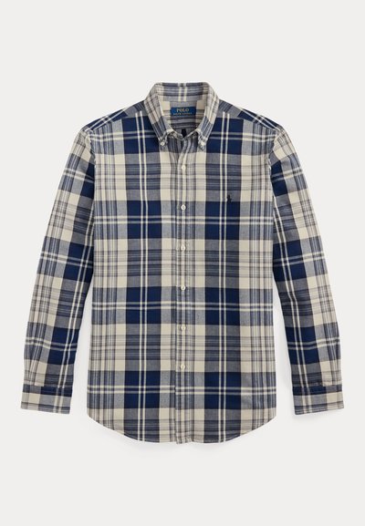 Μακρυμάνικο πουκάμισο με καρό σχέδιο σε μπλε και μπεζ χρώματα, με γιακά που κλείνει με κουμπιά, μικρό λογότυπο και κυρτή γραμμή στη βάση. Υφασμένο από βαμβακερό ύφασμα με απαλή υφή.