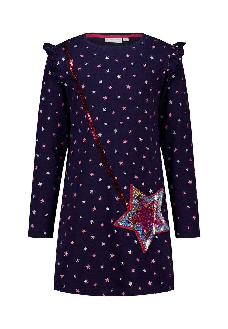 Marineblaues Langarmkleid mit pinken und silbernen Sternen, Rüschenschultern und einem roten, mit Pailletten besetzten, sternförmigen Umhänge-design.