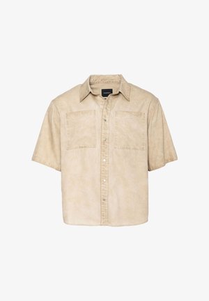 Lühikeste varrukatega särk beežist kangast, millel on tuhmunud tekstuur, sisaldades kahte rindtaskut ja esikinnistust metallist nööpidega.