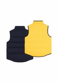 Obostrani bezrukavnik s jedne strane u mornarskoj boji s kviltanim uzorkom, a s druge strane u ravnoj žutoj boji, oboje s kontrastnim obrubima.