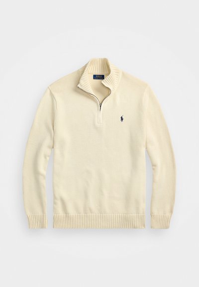 Kremna zip-up jopica iz pletenega materiala, s potrjenim ovratnikom in hemom ter majhnim izvezenim logotipom v temno modri barvi na prsih.