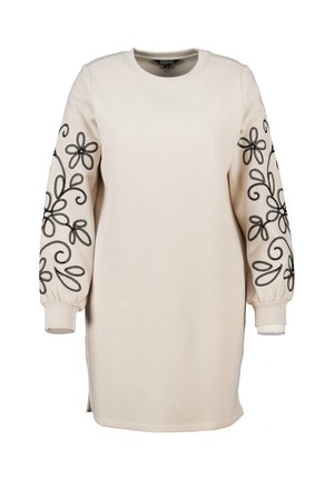 Beige lange mouwen jurk met zwarte geborduurde bloemenpatronen op de mouwen; ronde hals, losse pasvorm en geribbelde manchetten bij de polsen.