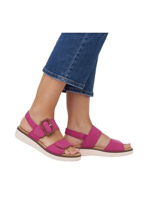 Fuchsia sandals with an adjustable strap, wide front band, and textured buckle detail. Rubber sole with a slight heel.