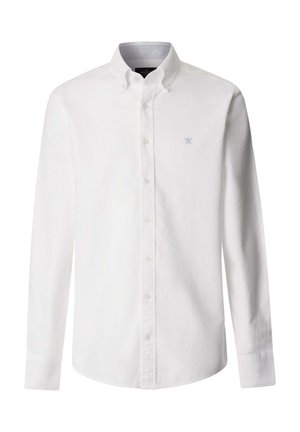 Bijela košulja s dugim rukavima, kopča se na gumbe, ovratnik je s gumbima i na lijevoj strani prsiju ima mali izvezeni logo ukriženih vesala.