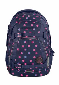Navy blue backpack with pink and light blue polka dots, featuring adjustable straps, a logo patch, and multiple zippered compartments.
