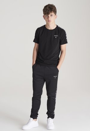 MEDLEY - Tracksuit bottoms - black